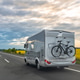 Motorhome driving on highway. Road travel with bicycle rack. Motorhome driving on highway. Road travel with bicycle rack. - PhotoDune Item for Sale