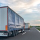 Cargo trucks on highway. Road freight transport and logistics content. Cargo trucks on highway. Road freight transport and logistics content. - PhotoDune Item for Sale