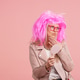 Woman with pink wig examining face aging well Woman with pink wig examining face aging well - PhotoDune Item for Sale