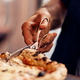 Close-Up of Hand Cutting Pizza with Scissors in a Serving Scene Close-Up of Hand Cutting Pizza with Scissors in a Serving Scene - PhotoDune Item for Sale
