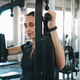 Gym woman exercise fitness machine strength training woman using gym machine indoors Gym woman exercise fitness machine strength training woman using gym machine indoors - PhotoDune Item for Sale