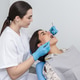 Dentist examines patient during a dental appointment in a modern clinic Dentist examines patient during a dental appointment in a modern clinic - PhotoDune Item for Sale