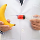 Male doctor making an injection to a banana with a syringe, penis health. Male doctor making an injection to a banana with a syringe, penis health. - PhotoDune Item for Sale