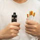 Man holding electronic cigarettes, no smoking. Man holding electronic cigarettes, no smoking. - PhotoDune Item for Sale