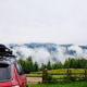 Traveling in the Carpathian Mountains with a car viewed against a cloudy sky and forest in the backg Traveling in the Carpathian Mountains with a car viewed against a cloudy sky and forest in the backg - PhotoDune Item for Sale