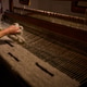 Weaver works on a loom in a craft studio showing traditional textile techniques and patterns Weaver works on a loom in a craft studio showing traditional textile techniques and patterns - PhotoDune Item for Sale