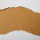 Ripped paper strip mockup with ragged horizontal edges on rustic brown cardboard Ripped paper strip mockup with ragged horizontal edges on rustic brown cardboard - PhotoDune Item for Sale