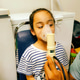 Asthma child using nebulizer in a clinic due to respiratory problem. Asthma child using nebulizer in a clinic due to respiratory problem. - PhotoDune Item for Sale