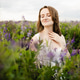 Woman in white dress standing in blooming purple field at summer sunset. Happy girl relaxing among w Woman in white dress standing in blooming purple field at summer sunset. Happy girl relaxing among w - PhotoDune Item for Sale