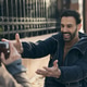 Man Smiling Outdoors While Being Photographed by A Girlfriend Man Smiling Outdoors While Being Photographed by A Girlfriend - PhotoDune Item for Sale