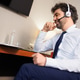 Smiling Businessman in Headset Talking During Online Meeting at Hotel Desk Smiling Businessman in Headset Talking During Online Meeting at Hotel Desk - PhotoDune Item for Sale