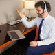 Businessman Having Video Call on Laptop in Hotel Room with Headset and Gesturing Businessman Having Video Call on Laptop in Hotel Room with Headset and Gesturing - PhotoDune Item for Sale