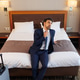 Tired Businessman Sitting on Hotel Bed After Business Trip with Suitcase in Modern Room Tired Businessman Sitting on Hotel Bed After Business Trip with Suitcase in Modern Room - PhotoDune Item for Sale