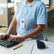 Woman Processing Pickup Orders at Delivery Service Desk Woman Processing Pickup Orders at Delivery Service Desk - PhotoDune Item for Sale