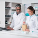 Middle Aged Man and Young Woman Preparing Pharmacy Order Middle Aged Man and Young Woman Preparing Pharmacy Order - PhotoDune Item for Sale