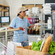 Woman Preparing Grocery Orders at Food Delivery Pickup Point Woman Preparing Grocery Orders at Food Delivery Pickup Point - PhotoDune Item for Sale