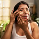 Portrait of Hispanic Adult Woman Applying Eye Patches at Home Portrait of Hispanic Adult Woman Applying Eye Patches at Home - PhotoDune Item for Sale