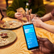 Black Man Showing Mobile Payment App While Friends Splitting Bill Black Man Showing Mobile Payment App While Friends Splitting Bill - PhotoDune Item for Sale