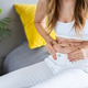 Young woman examining her midsection at home Young woman examining her midsection at home - PhotoDune Item for Sale