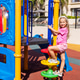 Young girl climbing on playground equipment on a sunny day Young girl climbing on playground equipment on a sunny day - PhotoDune Item for Sale