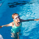 Young girl swimming in a pool with goggles Young girl swimming in a pool with goggles - PhotoDune Item for Sale
