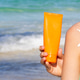 Girl Holding Sunscreen Bottle at the Beach With Sunblock Design on Shoulder Girl Holding Sunscreen Bottle at the Beach With Sunblock Design on Shoulder - PhotoDune Item for Sale