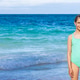 Young girl holding a floatation ring at a beach on a sunny day Young girl holding a floatation ring at a beach on a sunny day - PhotoDune Item for Sale
