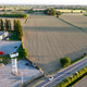 Rural road traffic flow with vehicles moving alongside agricultural fields separating from an empty Rural road traffic flow with vehicles moving alongside agricultural fields separating from an empty - PhotoDune Item for Sale