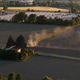 Po Valley farmland experiencing a dry springtime, with an agricultural machine creating dust while w Po Valley farmland experiencing a dry springtime, with an agricultural machine creating dust while w - PhotoDune Item for Sale