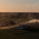 Po Valley farmland experiencing drought conditions, a tractor working the dusty fields, and an irrig Po Valley farmland experiencing drought conditions, a tractor working the dusty fields, and an irrig - PhotoDune Item for Sale