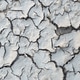 The surface of the earth was cracked by drought, cracks and erosion in the soil. Brown dry soil or c The surface of the earth was cracked by drought, cracks and erosion in the soil. Brown dry soil or c - PhotoDune Item for Sale