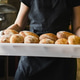 Smiling Female Baker Holding Fresh Artisan Sourdough Bread in Bakery Smiling Female Baker Holding Fresh Artisan Sourdough Bread in Bakery - PhotoDune Item for Sale