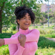 Young woman smiling stretching arm in park Young woman smiling stretching arm in park - PhotoDune Item for Sale
