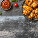 Barbecue chicken wings with sauce on a stone surface. Traditional baked bbq buffalo. Tasty snack for Barbecue chicken wings with sauce on a stone surface. Traditional baked bbq buffalo. Tasty snack for - PhotoDune Item for Sale