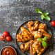 Barbecue chicken wings with sauce on a stone surface. Traditional baked bbq buffalo. Tasty snack for Barbecue chicken wings with sauce on a stone surface. Traditional baked bbq buffalo. Tasty snack for - PhotoDune Item for Sale