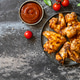 Barbecue chicken wings with sauce on a stone surface. Traditional baked bbq buffalo. Tasty snack for Barbecue chicken wings with sauce on a stone surface. Traditional baked bbq buffalo. Tasty snack for - PhotoDune Item for Sale