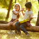 Happy little boy and girl in casual clothes sitting on log in forest on warm sunny day, enjoying fre Happy little boy and girl in casual clothes sitting on log in forest on warm sunny day, enjoying fre - PhotoDune Item for Sale