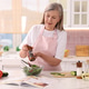 Senior woman adding pepper into bowl with salad at table in kitchen Senior woman adding pepper into bowl with salad at table in kitchen - PhotoDune Item for Sale