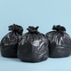 Plastic garbage bags on light blue background Plastic garbage bags on light blue background - PhotoDune Item for Sale