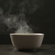 Steaming ceramic bowl on grey table against dark background Steaming ceramic bowl on grey table against dark background - PhotoDune Item for Sale