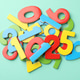 Pile of colorful numbers on turquoise background, flat lay Pile of colorful numbers on turquoise background, flat lay - PhotoDune Item for Sale