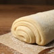 Raw puff pastry dough on wooden table, closeup Raw puff pastry dough on wooden table, closeup - PhotoDune Item for Sale
