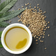 Hemp oil, seeds and leaves on black table, flat lay Hemp oil, seeds and leaves on black table, flat lay - PhotoDune Item for Sale
