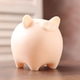 Beige piggy bank on wooden table indoors, closeup Beige piggy bank on wooden table indoors, closeup - PhotoDune Item for Sale