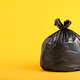 One plastic garbage bag on yellow background, space for text One plastic garbage bag on yellow background, space for text - PhotoDune Item for Sale