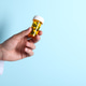 Pharmacist holding pills in bottle on light blue background, closeup. Space for text Pharmacist holding pills in bottle on light blue background, closeup. Space for text - PhotoDune Item for Sale