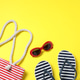 Bag with beach accessories on yellow background, flat lay. Space for text Bag with beach accessories on yellow background, flat lay. Space for text - PhotoDune Item for Sale