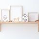 Different wooden toys and decor on shelf near white wall in child's room Different wooden toys and decor on shelf near white wall in child's room - PhotoDune Item for Sale
