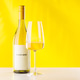 White wine bottle and glass on yellow background elegant drink setup White wine bottle and glass on yellow background elegant drink setup - PhotoDune Item for Sale