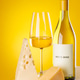 White wine with cheese pieces on yellow background gourmet composition White wine with cheese pieces on yellow background gourmet composition - PhotoDune Item for Sale